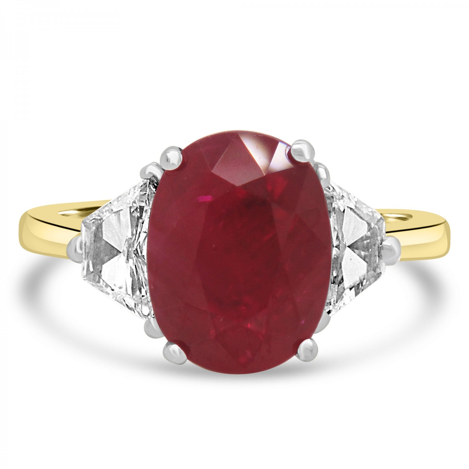 Oval cut ruby and diamond three stne engagement ring from fogal and barnes fine jewellers of harrogate. set on 18 k yellow gold and platinum head.