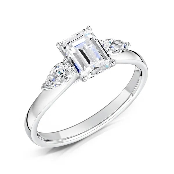 Emerald cut diamond and pear three stone engagement ring set on 18k white gold from fogal and barnes fine jewellers of Harrogate