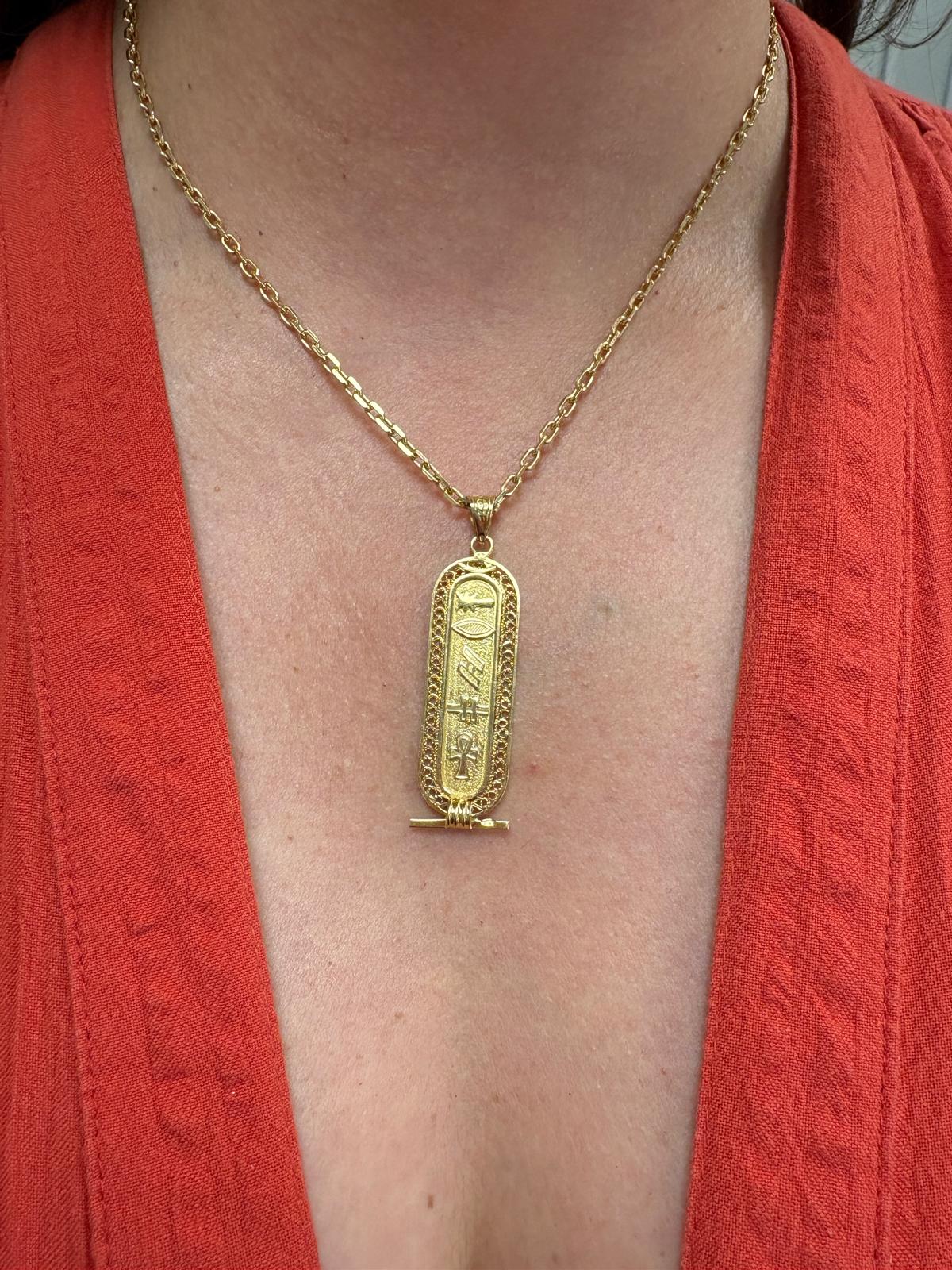 Vintage Egyptian 18ct yellow gold cartouche pendant with hieroglyphic engravings including ankh symbol and intricate filigree border, 3.96g, shown front and back and worn on neck, available at Fogal & Barnes Harrogate