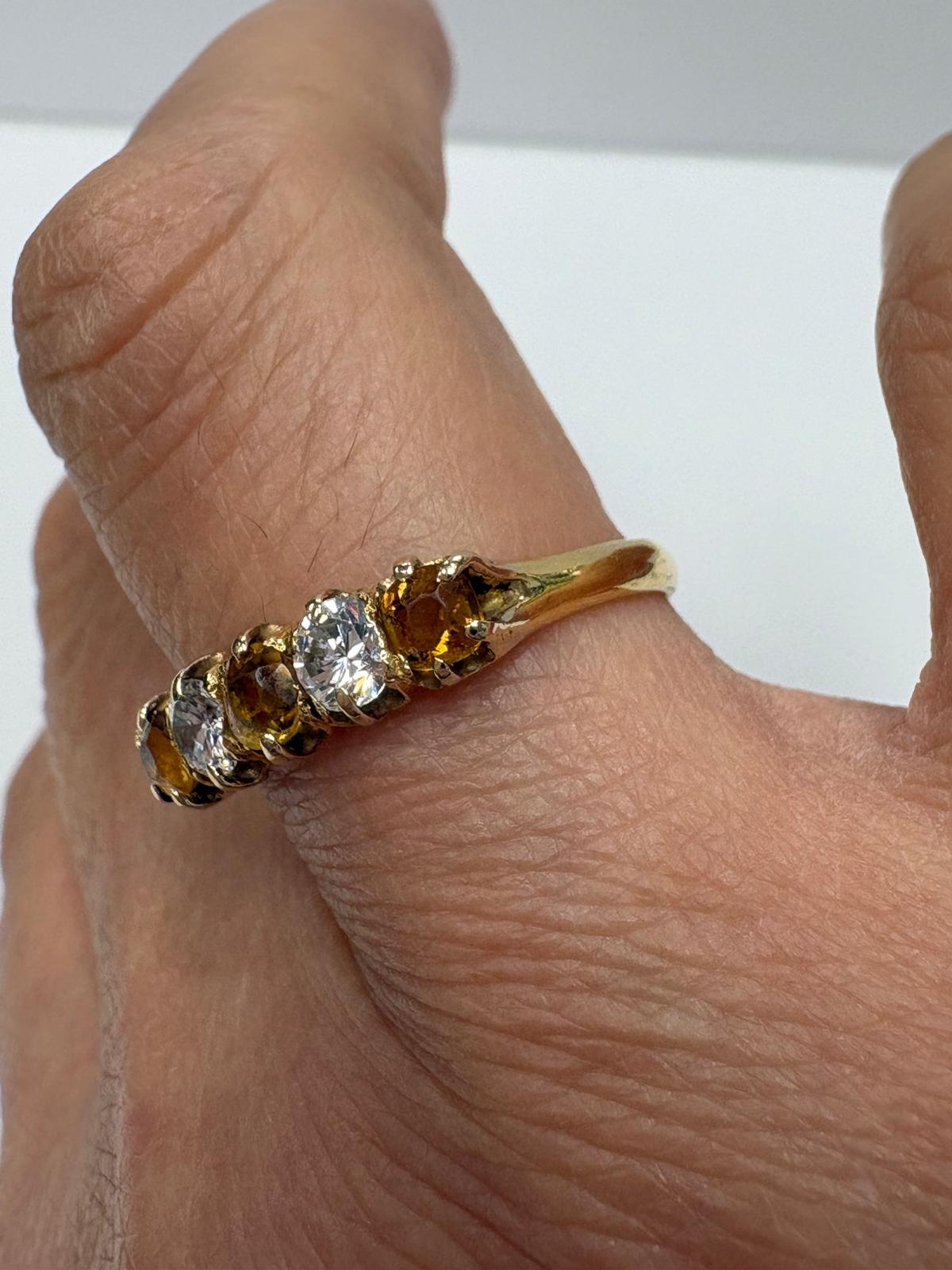 Vintage 18ct yellow gold citrine and white stone five stone graduating ring size S½ with three amber citrines alternating with two white stones in claw setting, shown on white background and worn on finger, available at Fogal & Barnes Harrogate