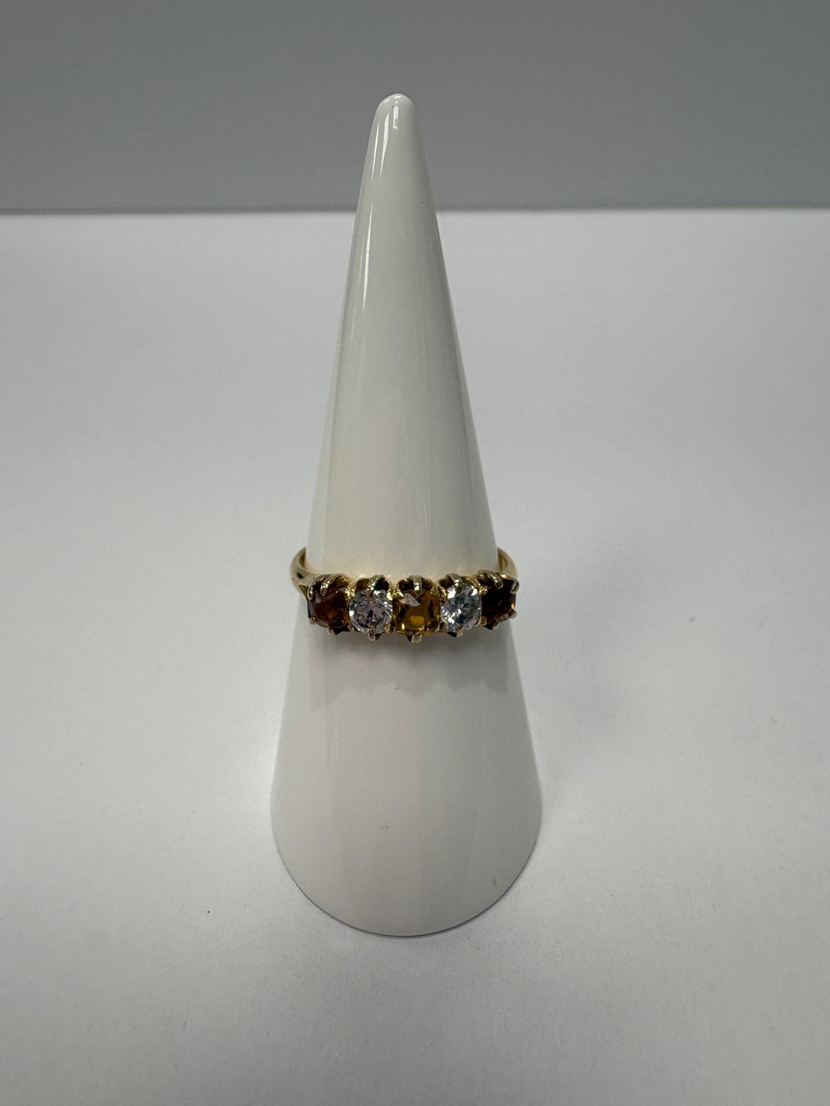 Vintage 18ct yellow gold citrine and white stone five stone graduating ring size S½ with three amber citrines alternating with two white stones in claw setting, shown on white background and worn on finger, available at Fogal & Barnes Harrogate