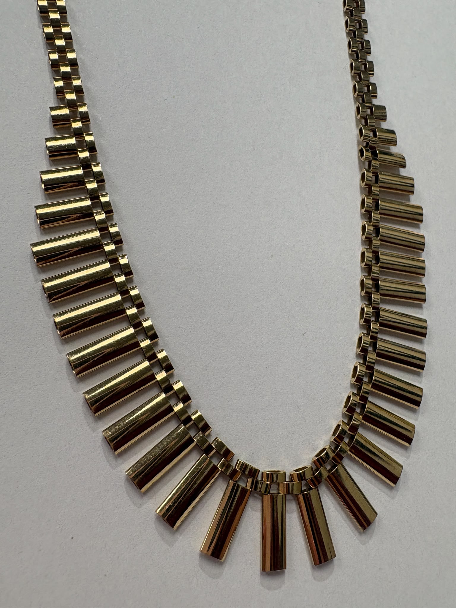 Vintage 1970s 9ct yellow gold graduating fringe necklace with alternating textured and polished cylindrical bars on a brick link chain with safety clasp, 20.50g, shown on white background, available at Fogal & Barnes Harrogate
