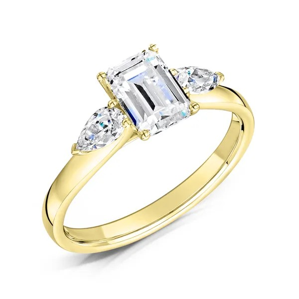 Emerald cut diamond and pear three stone engagement ring set on 18k yellow gold from fogal and barnes fine jewellers of Harrogate
