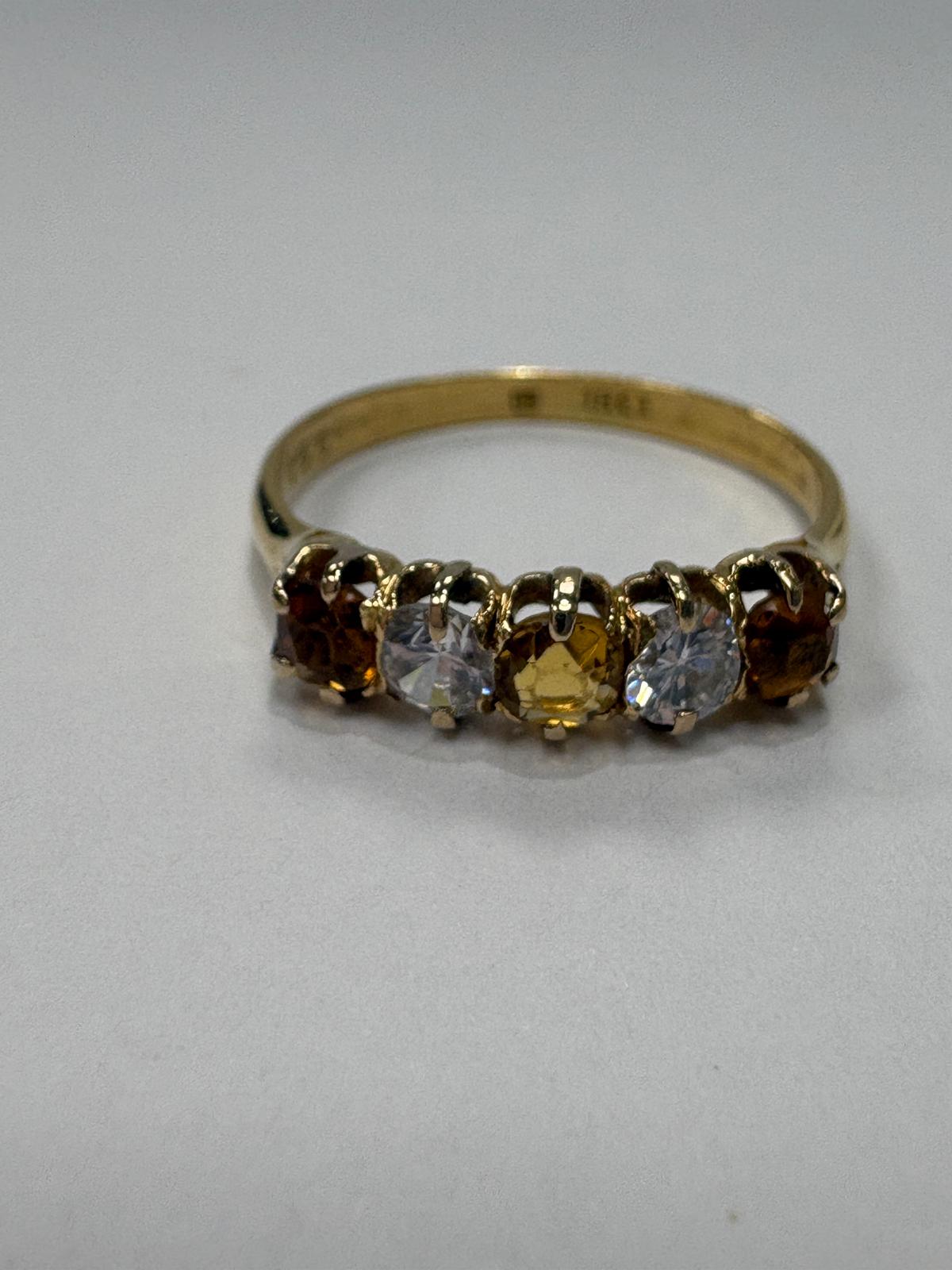 Vintage 18ct yellow gold citrine and white stone five stone graduating ring size S½ with three amber citrines alternating with two white stones in claw setting, shown on white background and worn on finger, available at Fogal & Barnes Harrogate
