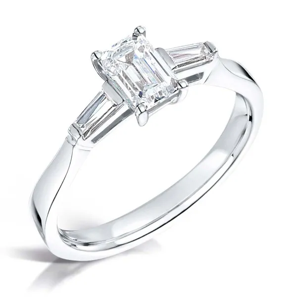 Emerald cut 1.00ct diamond center with 2 tapered baguettes set on 18k white gold from fogal and barnes fine jewellers of harrogate. Three stone diamond engagement ring