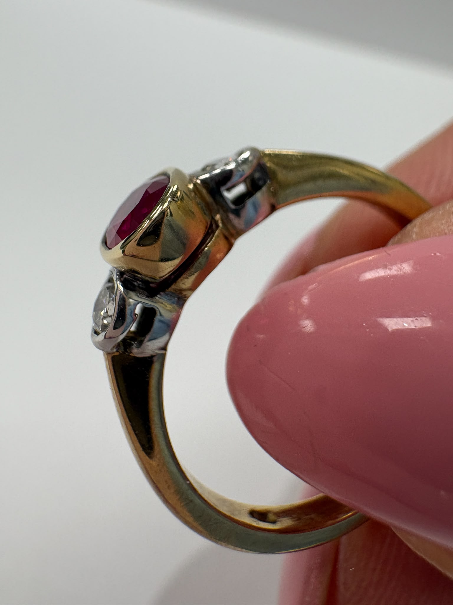 ruby and diamond ring, bezel set ruby ring, two tone gold ruby ring, second hand ruby ring UK, pre-loved three stone ring, vintage ruby diamond ring, 9ct gold ruby ring, ruby diamond trilogy ring, second hand jewellery Harrogate, second hand jewellery Leeds, second hand jewellery York, second hand jewellery Yorkshire, pre-owned ruby ring UK, bezel set gemstone ring, buy second hand ruby ring, ruby ring size N, ruby ring near me, fine jewellery Harrogate, pre-loved jewellery Yorkshire