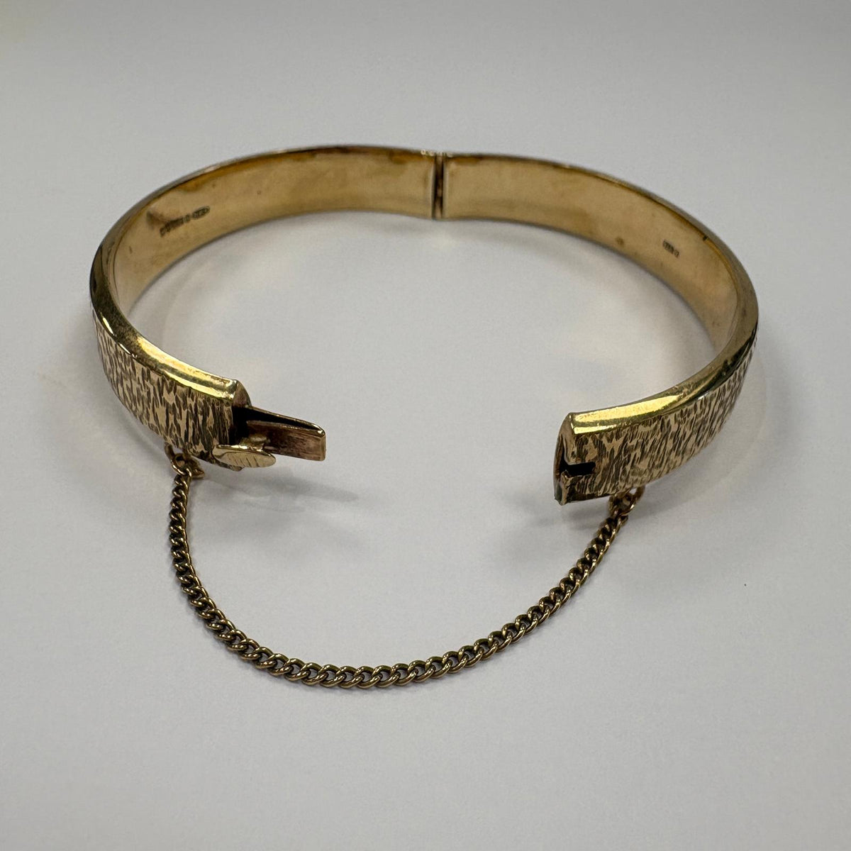 vintage gold bangle UK, bark effect bangle, 1970s gold bangle, 9ct gold hinged bangle, 1973 birth year gift, textured gold bangle, vintage 9ct gold bracelet, gold bangle with safety chain