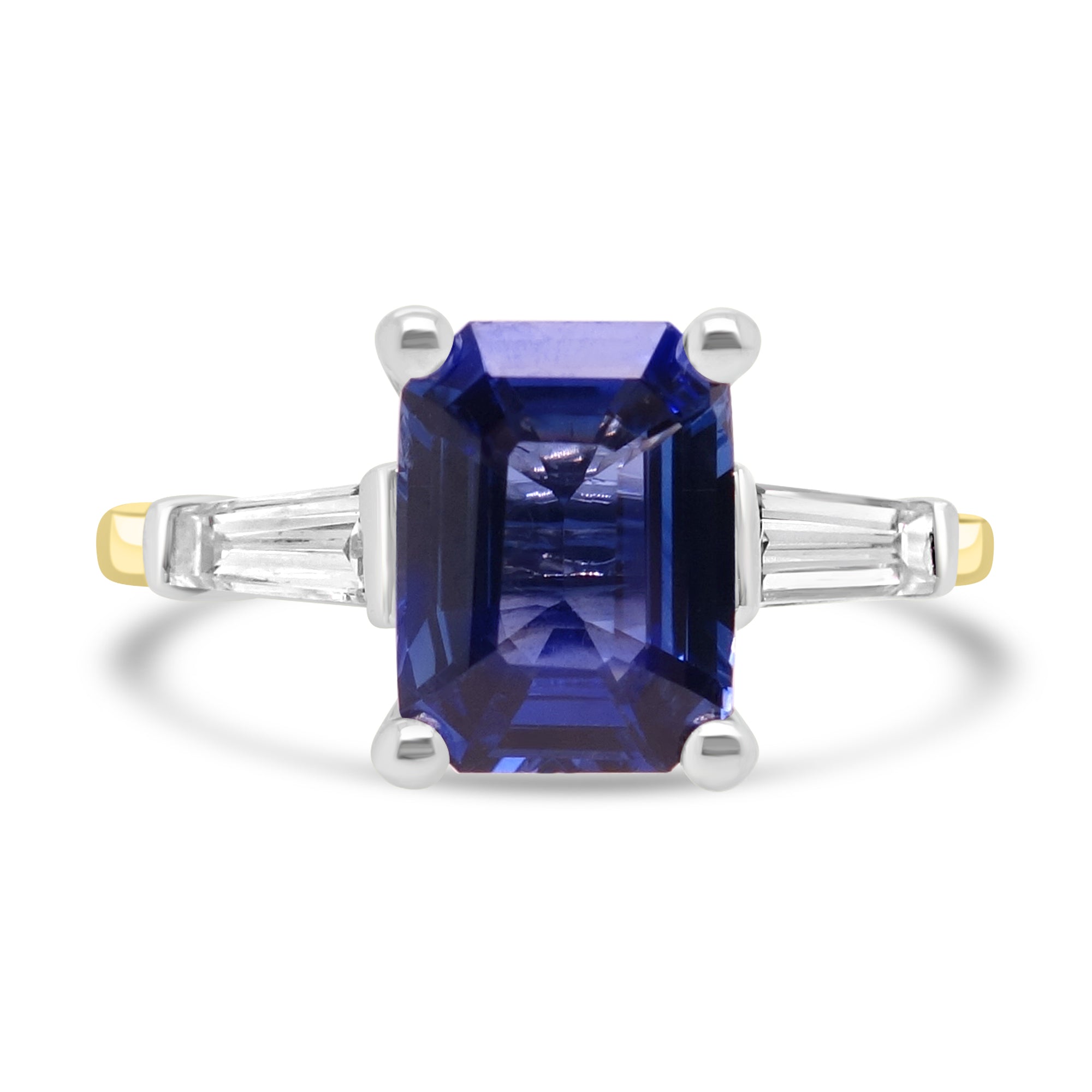 Emerald cut sapphire and diamond three stone engagement ring set on 18k yellow gold from fogal and barnes fine jewellers of Harrogate