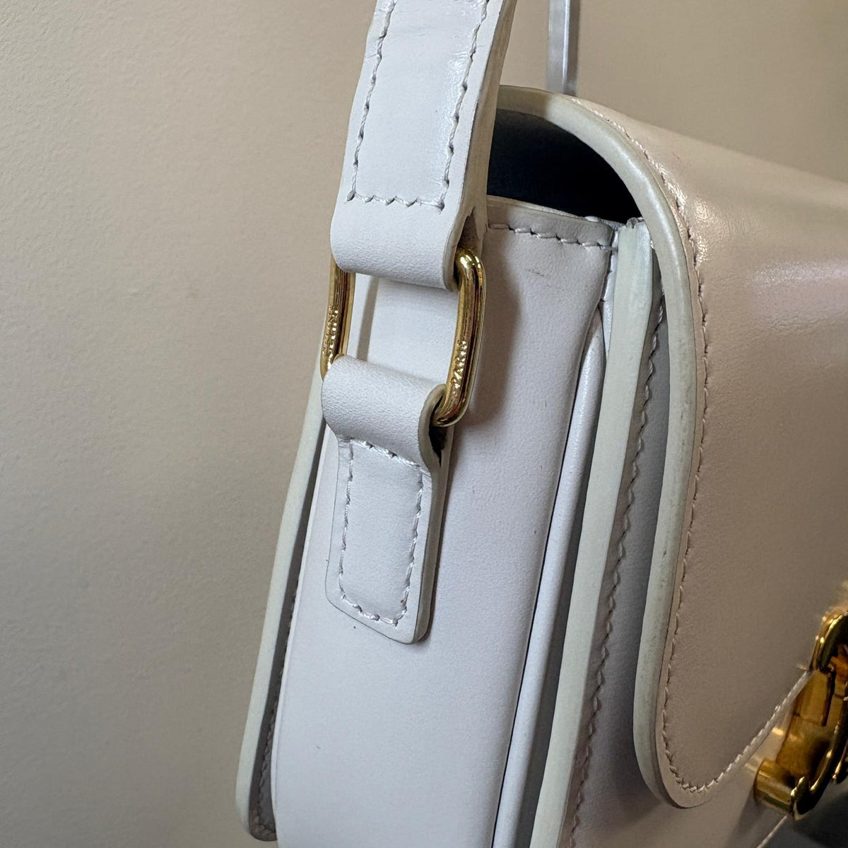Celine Teen Triomphe, pre-loved Celine bag UK, white Celine Triomphe bag, second hand Celine handbag, Celine Triomphe shoulder bag, Celine crossbody bag, preowned designer handbag UK, Celine shiny calfskin
