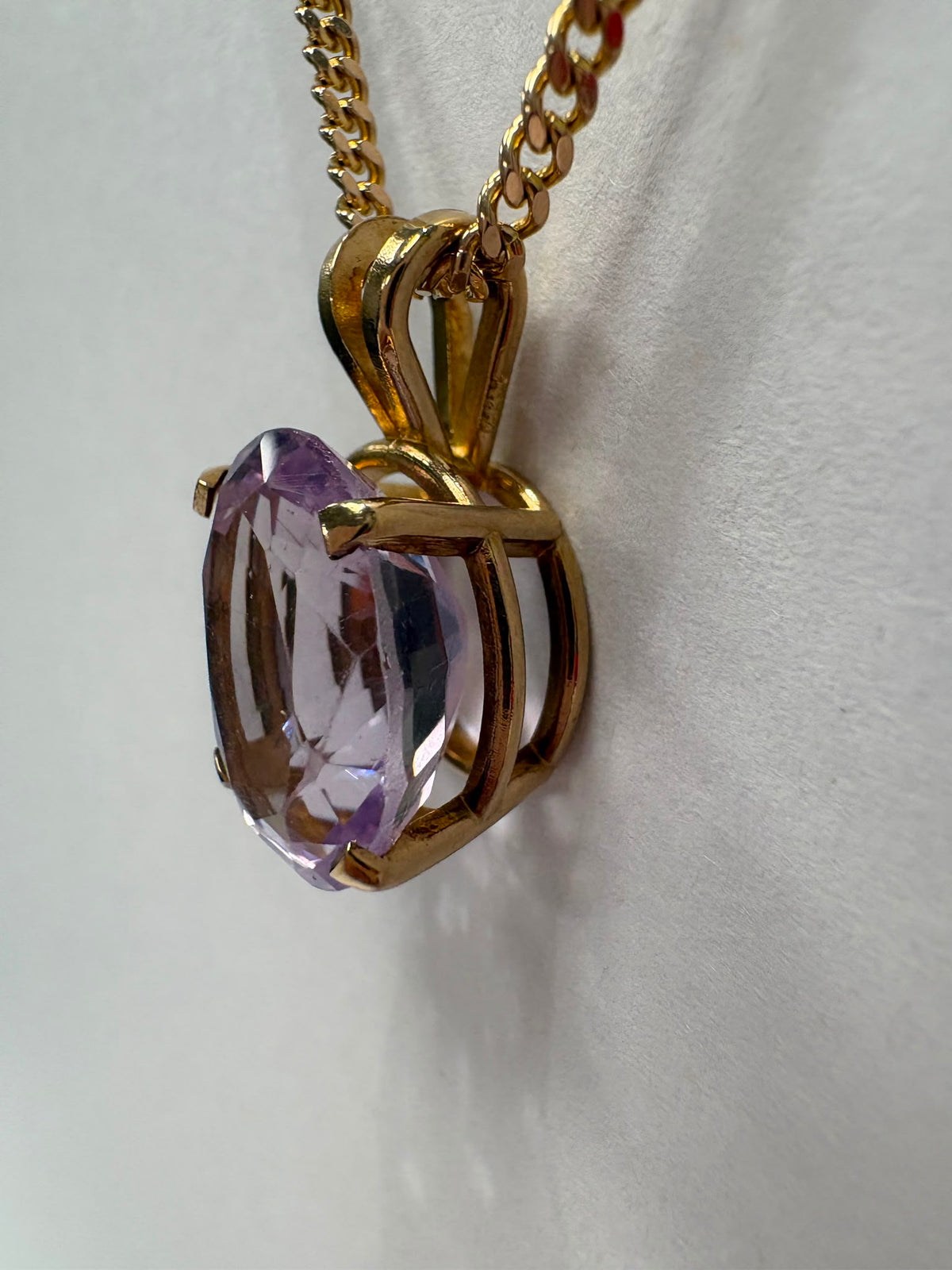 Natural 4.5ct oval amethyst pendant in 14ct gold, with 9ct gold curb chain, 20 inches, 13.27g total. Sold together or separately. Fogal & Barnes, Harrogate.