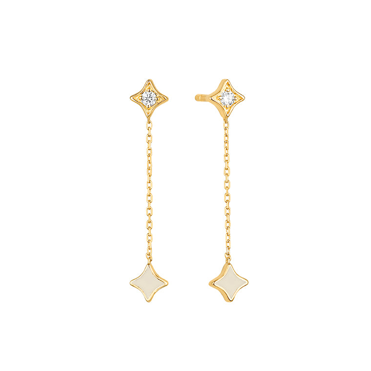Yellow gold diamond star stud and white enamel chain drop earrings featuring a diamond set four pointed star with fine chain drop and white enamel star, shown on white background