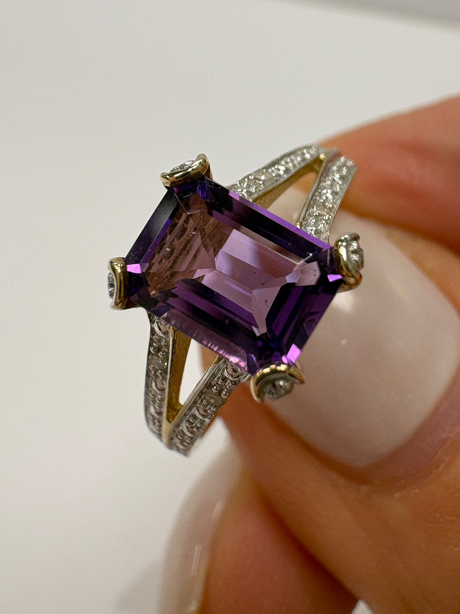 Emerald-cut amethyst and diamond ring with split-shoulder setting, 9ct gold, size N. Pre-loved, authenticated. Shop coloured gemstone jewellery in Harrogate.