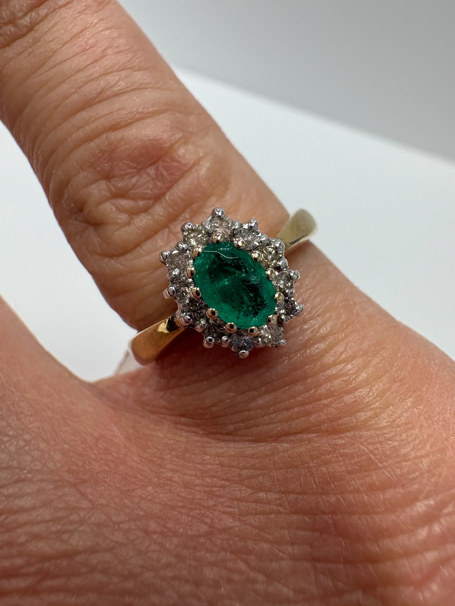 emerald and diamond ring, emerald cluster ring, second hand emerald ring UK, pre-loved emerald ring, vintage emerald ring, 9ct gold emerald ring, oval emerald ring, May birthstone ring, second hand jewellery Harrogate, second hand jewellery Leeds, second hand jewellery York, second hand jewellery Yorkshire, pre-owned emerald ring UK, antique style emerald ring, classic emerald cluster ring, buy second hand emerald ring, emerald ring size N, emerald ring near me, fine jewellery Harrogate, pre-loved jewellery