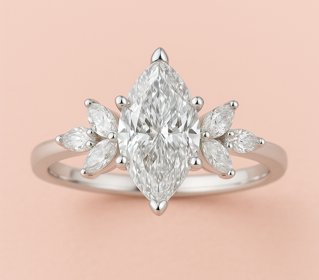 Marquise diamond engagement ring with floral marquise side stones in white gold on a soft pink background.
