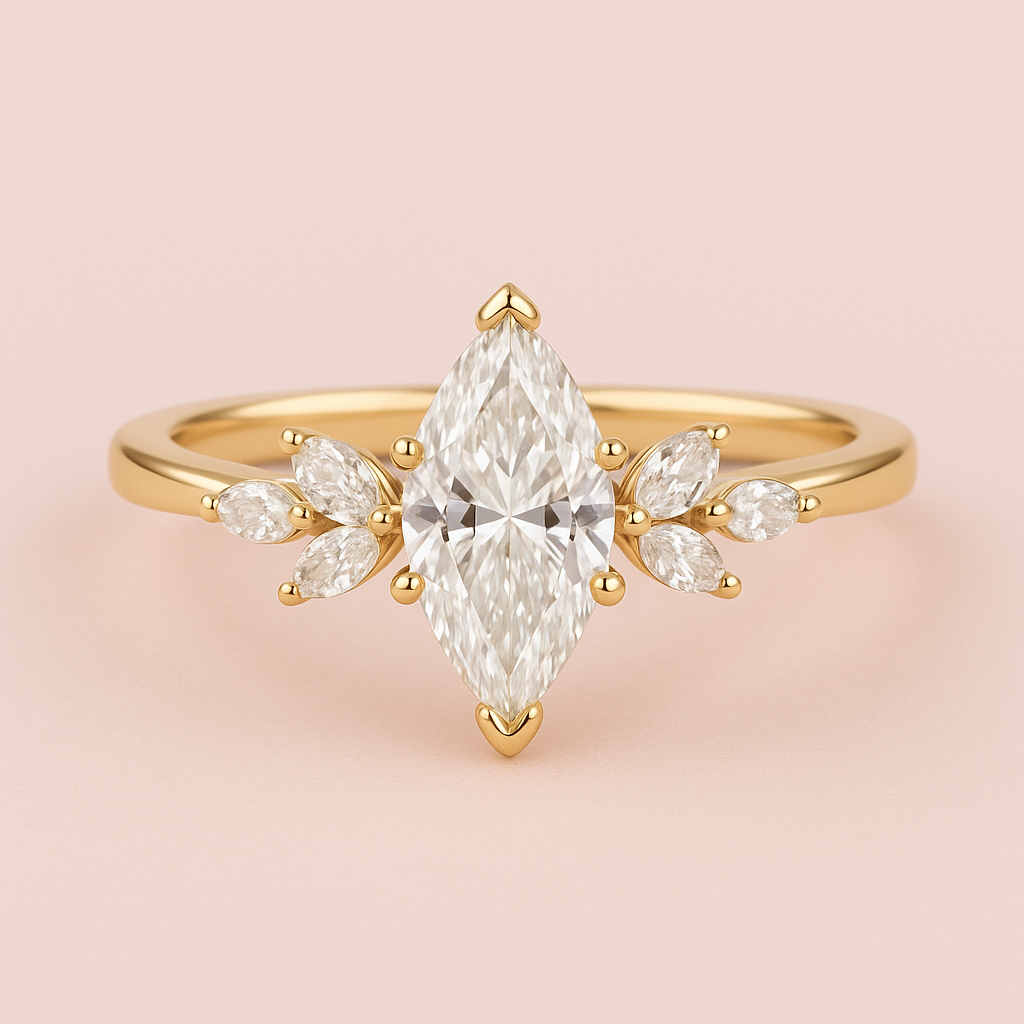 Marquise diamond engagement ring with floral marquise side stones in yellow gold on a soft pink background.