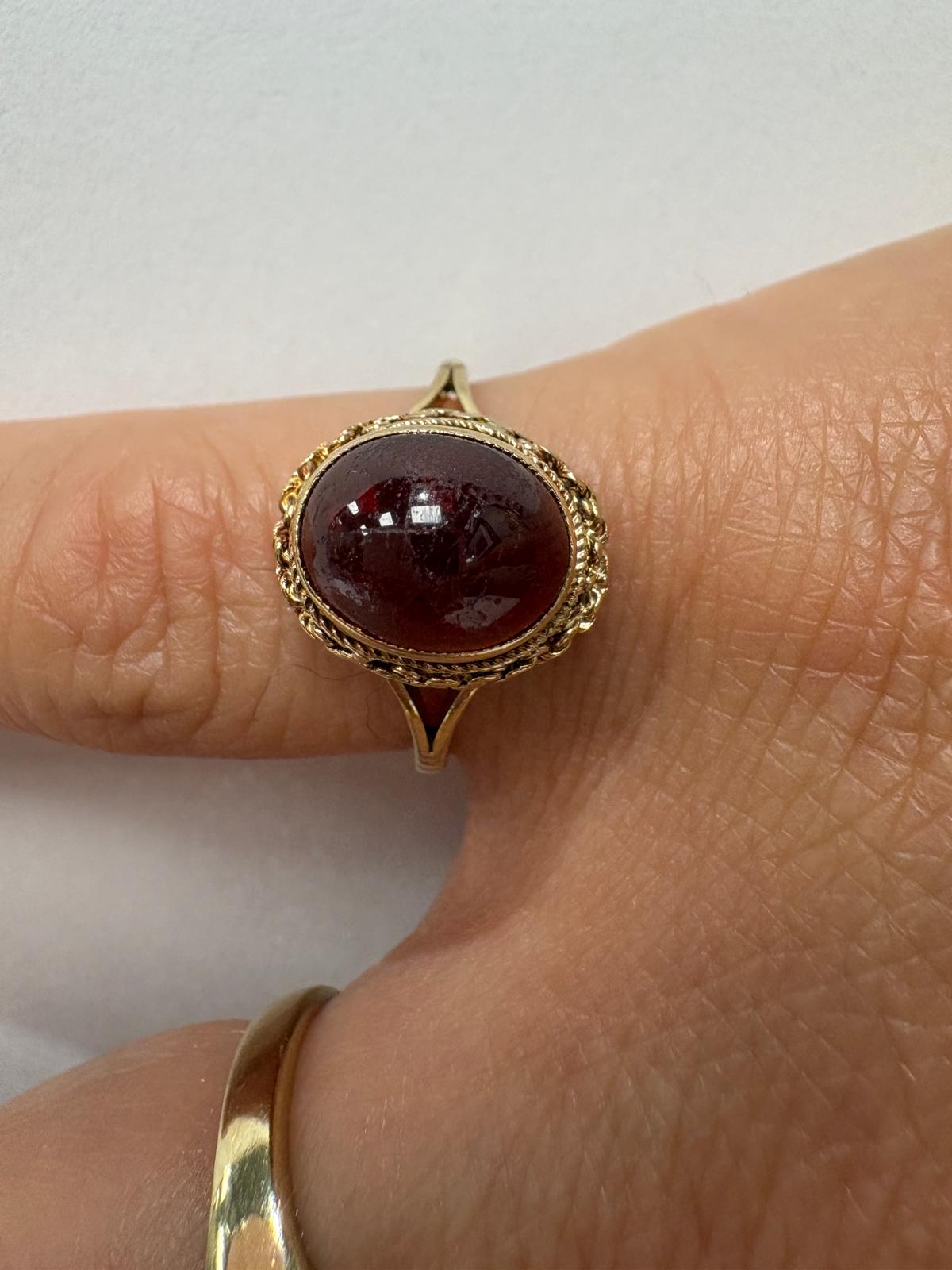 Close-up of oval garnet cabochon ring in 9ct gold, size O