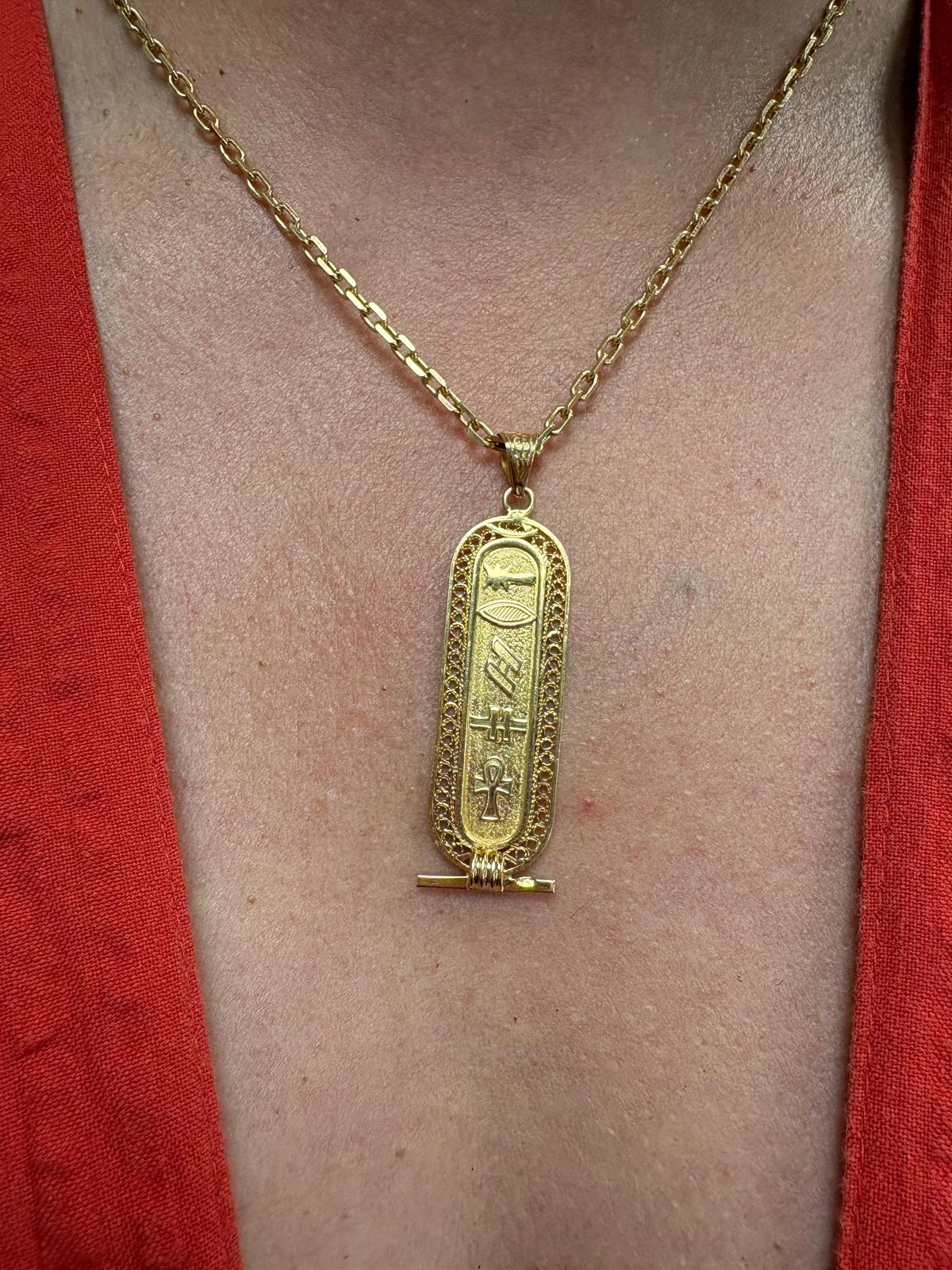 Vintage Egyptian 18ct yellow gold cartouche pendant with hieroglyphic engravings including ankh symbol and intricate filigree border, 3.96g, shown front and back and worn on neck, available at Fogal & Barnes Harrogate