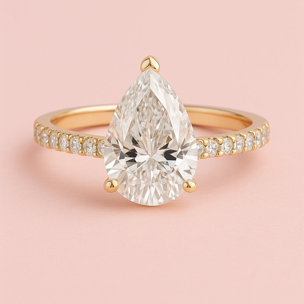Beatrice pear cut lab grown diamond engagement ring with diamond band in white gold on a dusky pink background fogal and barnes Harrogate