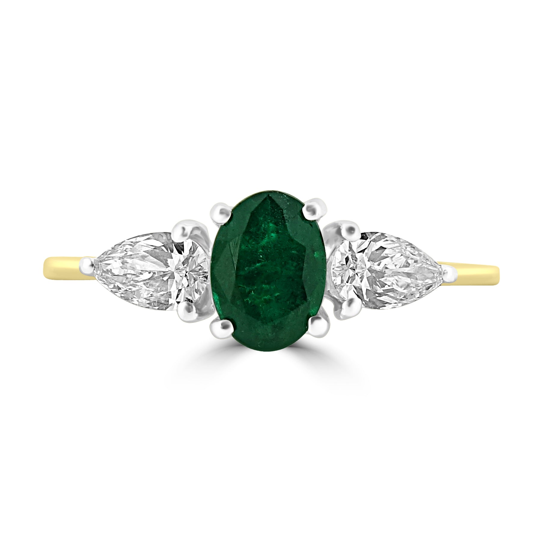 Oval cut emerald and diamond three stne engagement ring set on 18k yellow gold from fogal and barnes fine jewellers of harrogate.