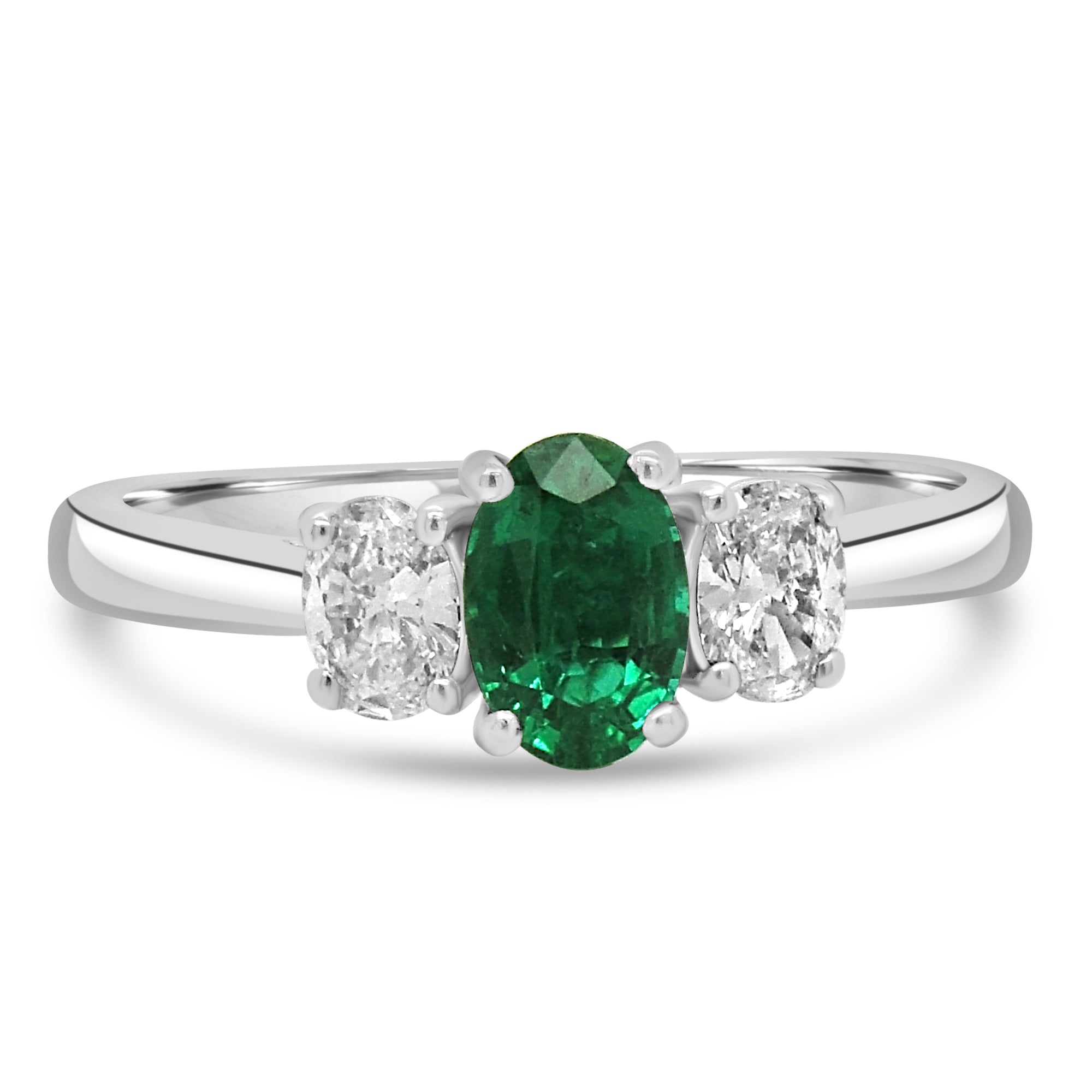 Oval cut emerald and diamond three stone engagement ring set on platinum from fogal and barnes fine jewellers of harrogate.