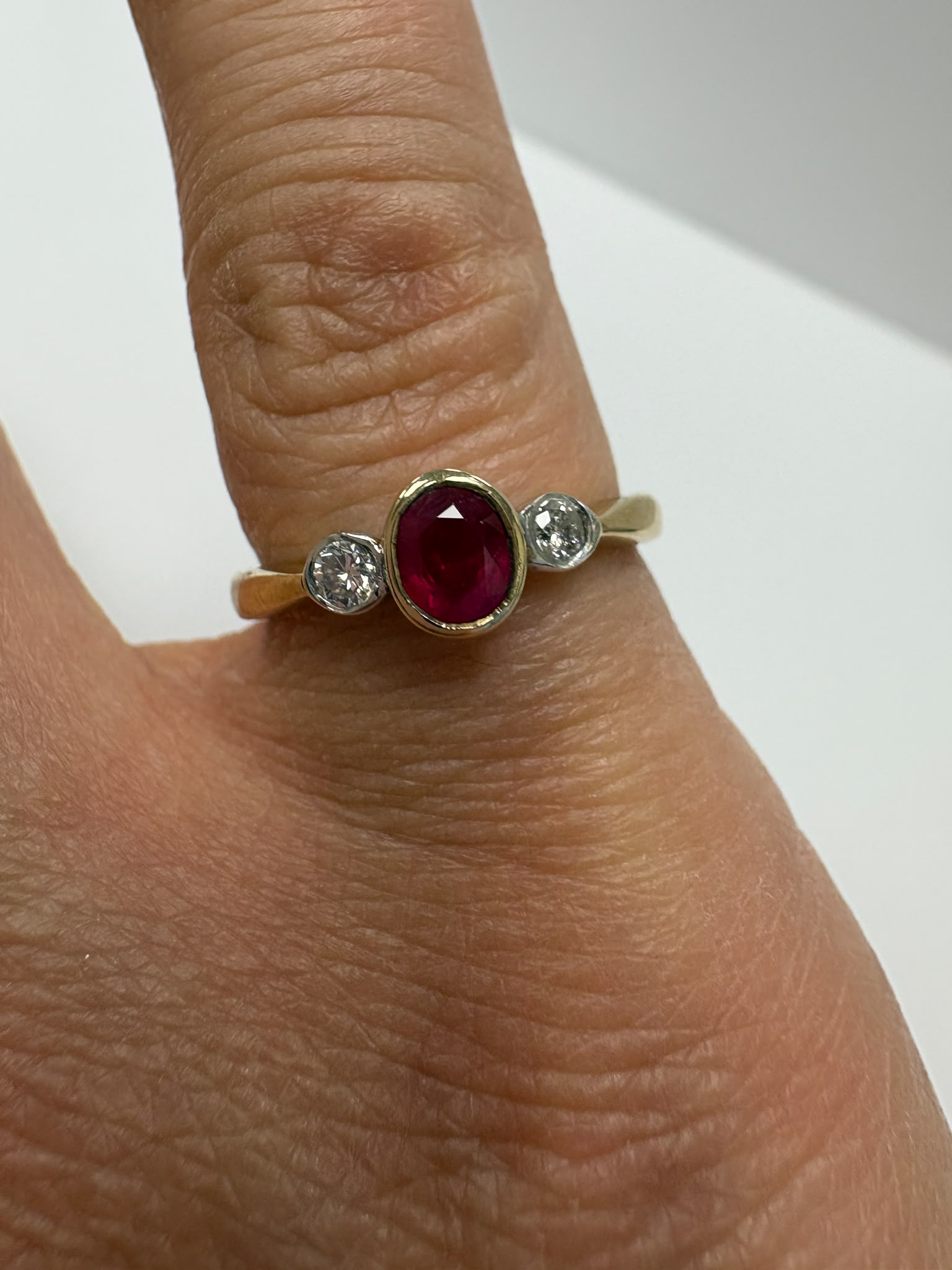 ruby and diamond ring, bezel set ruby ring, two tone gold ruby ring, second hand ruby ring UK, pre-loved three stone ring, vintage ruby diamond ring, 9ct gold ruby ring, ruby diamond trilogy ring, second hand jewellery Harrogate, second hand jewellery Leeds, second hand jewellery York, second hand jewellery Yorkshire, pre-owned ruby ring UK, bezel set gemstone ring, buy second hand ruby ring, ruby ring size N, ruby ring near me, fine jewellery Harrogate, pre-loved jewellery Yorkshire