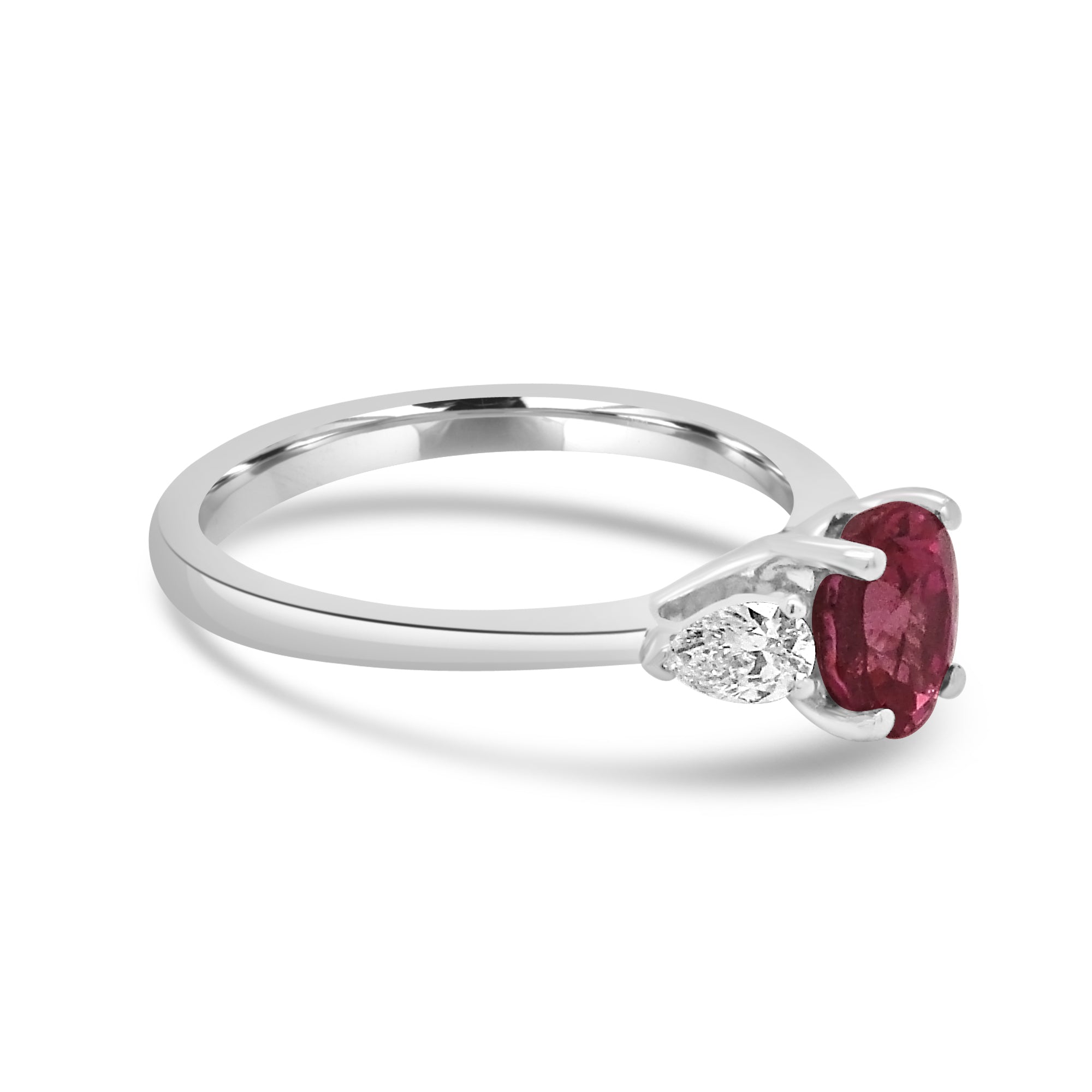 Oval pink sapphire and diamond pear three stone engagement ring set on platinum from fogal and barnes fine jewellers of Harrogate
