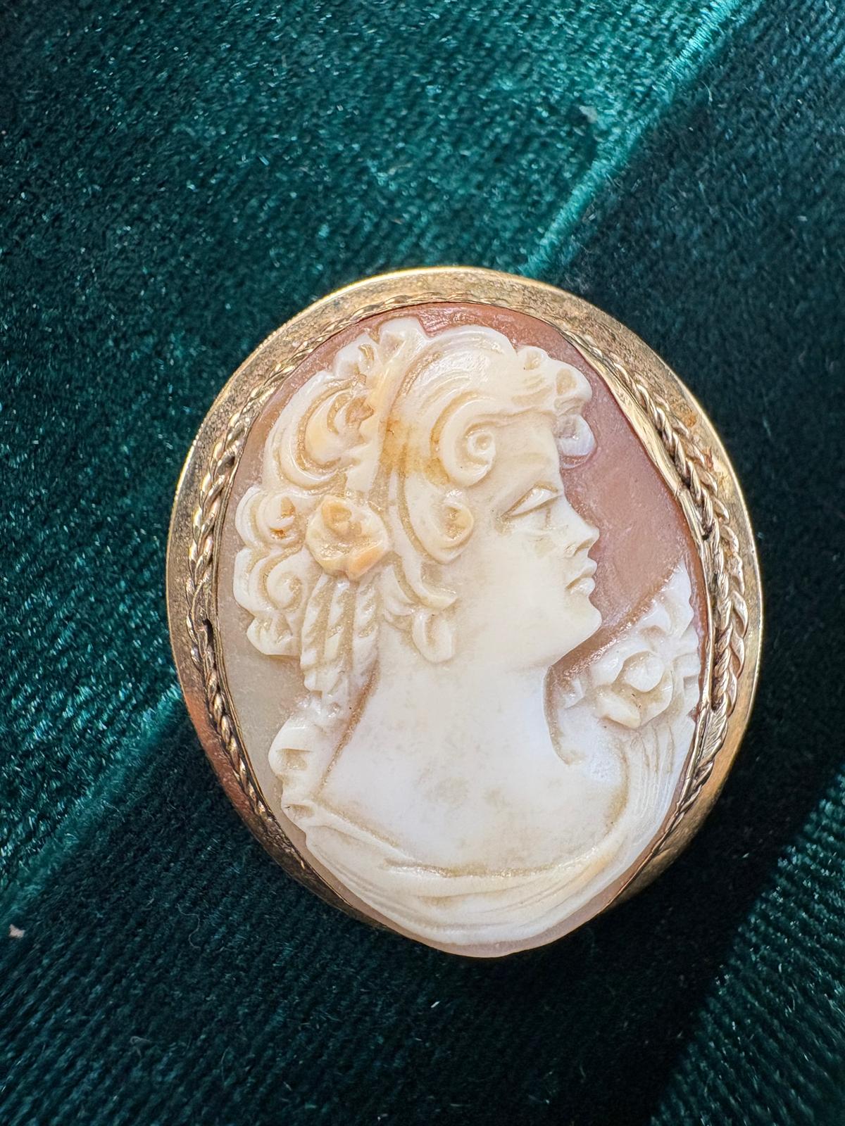 Victorian 9ct gold shell cameo brooch close-up front on teal background — detailed hand-carved female profile with roses in hair