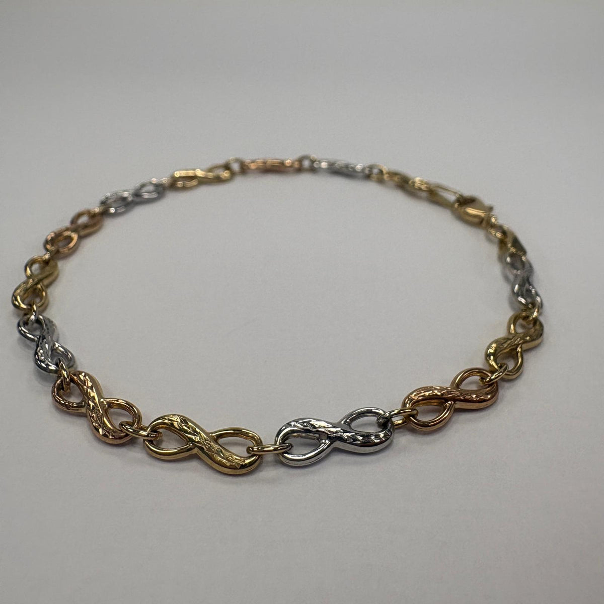 infinity bracelet gold, 9ct gold infinity bracelet, tri-colour gold bracelet, three tone gold bracelet UK, pre-loved gold bracelet, anniversary gift bracelet, rose gold infinity bracelet, second hand gold bracelet