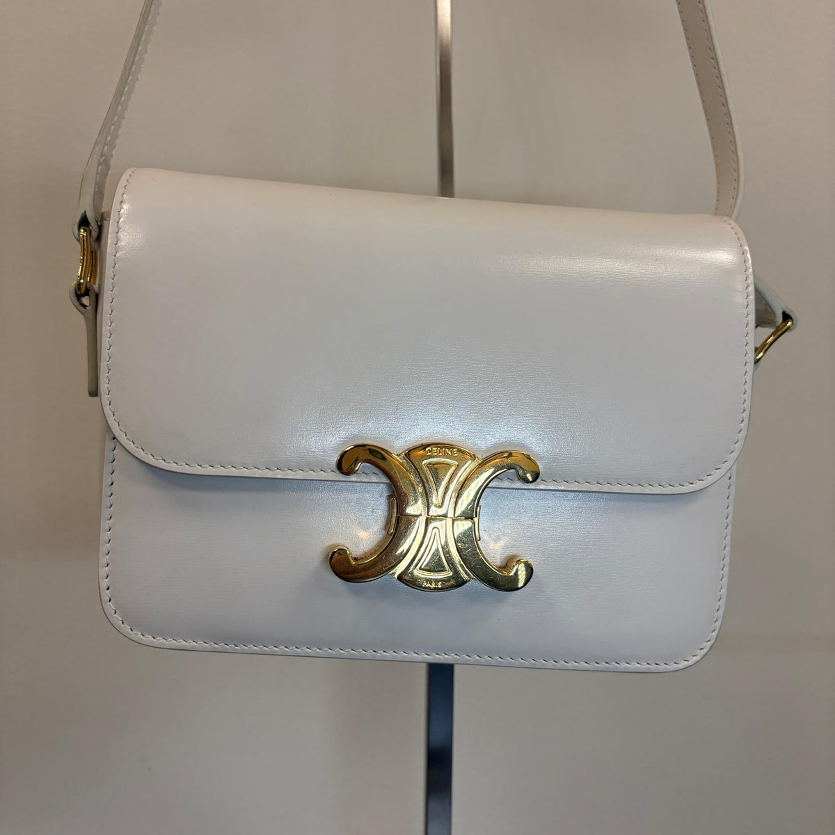 Celine Teen Triomphe, pre-loved Celine bag UK, white Celine Triomphe bag, second hand Celine handbag, Celine Triomphe shoulder bag, Celine crossbody bag, preowned designer handbag UK, Celine shiny calfskin