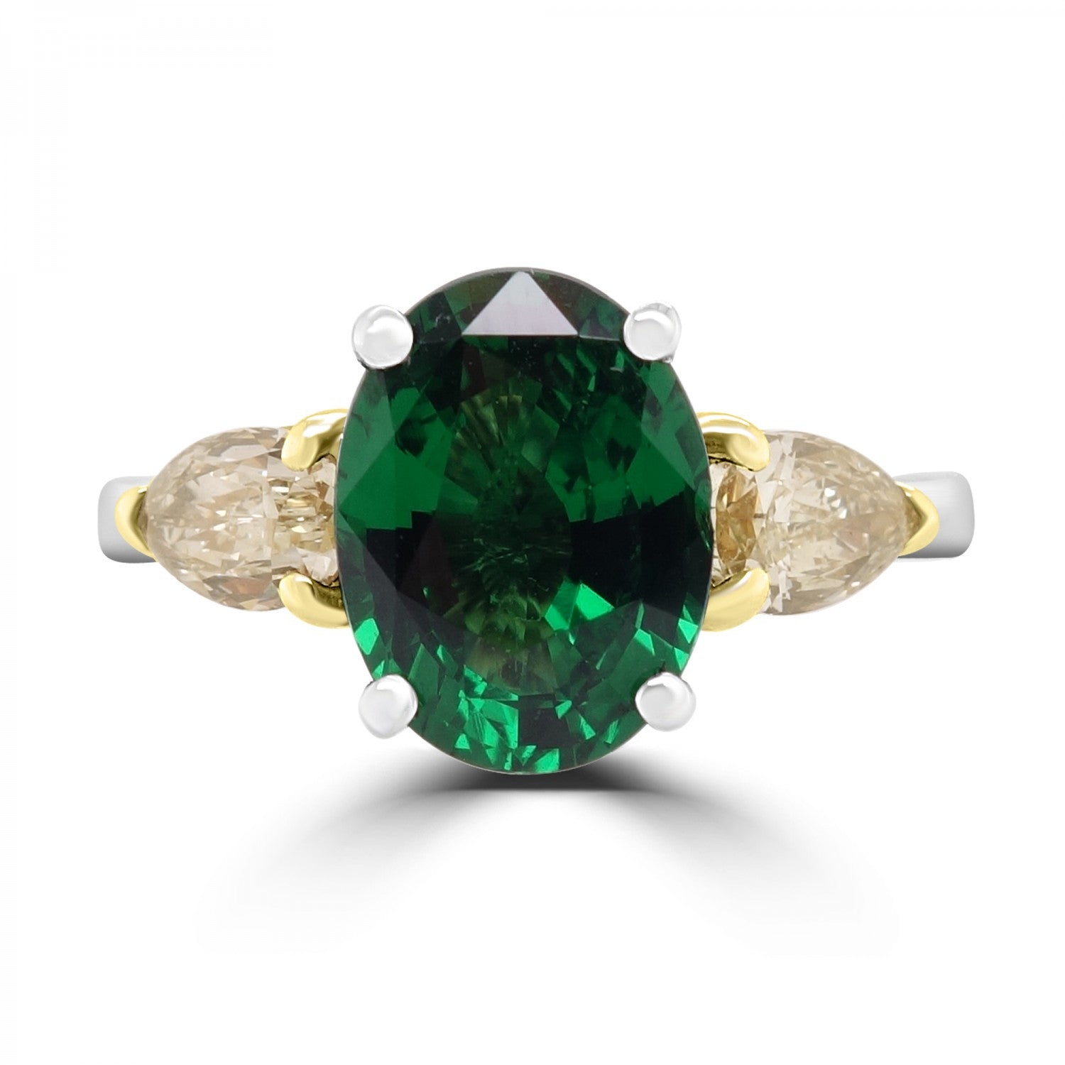 Oval Cut Emerald and pear cut yellow diamond three stone from fogal and barnes fine jewellers of harrogate set on platinum.
