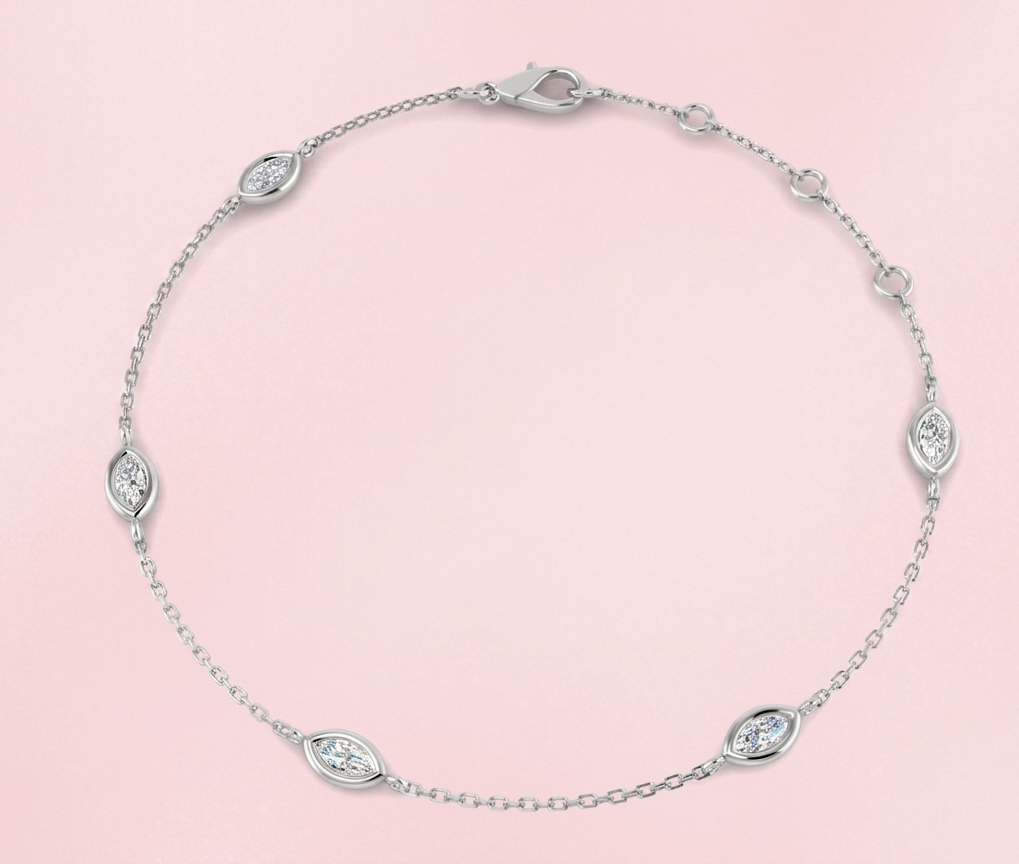 Bezel set lab grown marquise diamond station bracelet featuring five horizontally set marquise diamonds on a delicate gold chain with lobster clasp, shown in yellow gold on white background