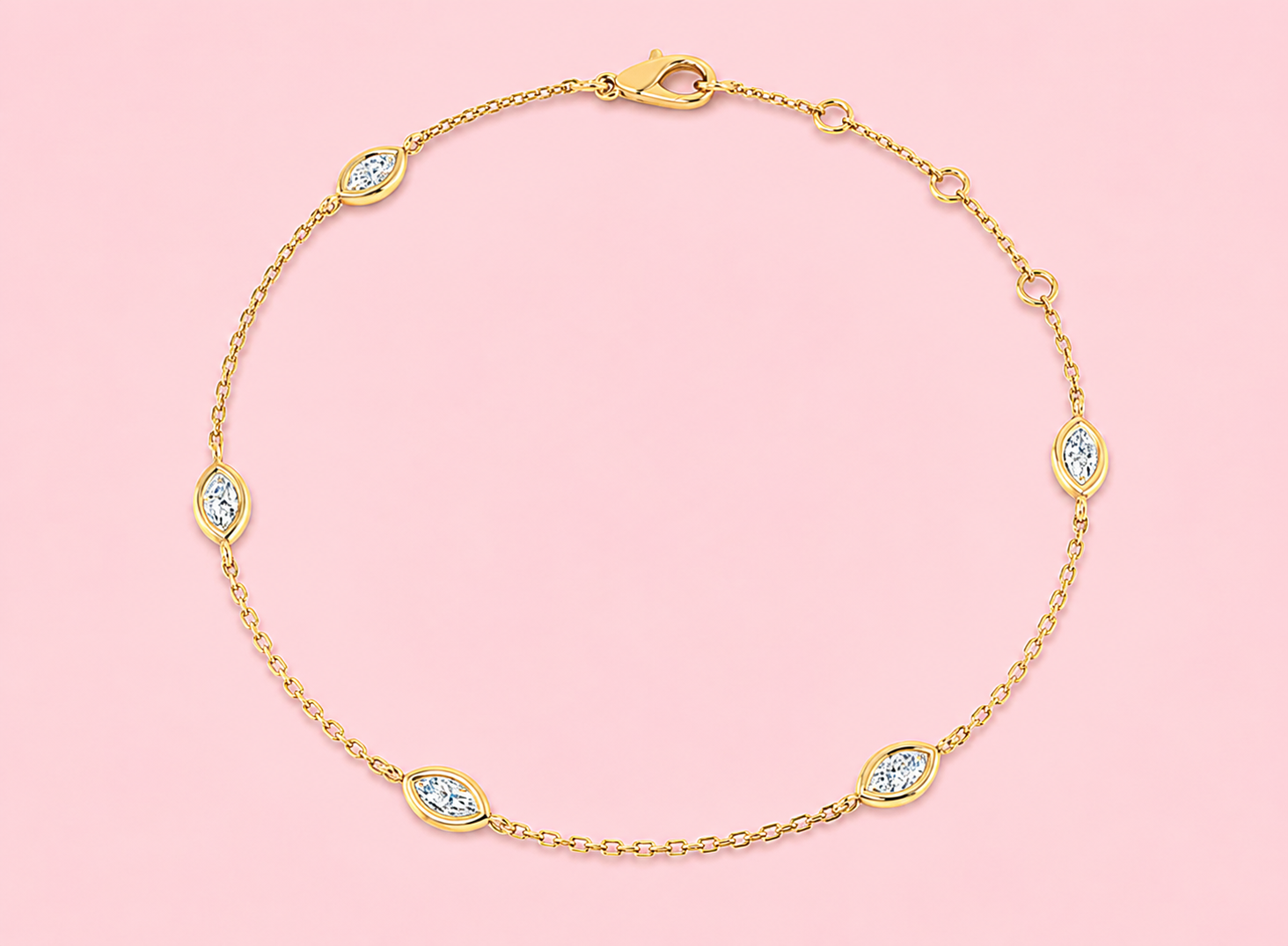 Bezel set lab grown marquise diamond station bracelet featuring five horizontally set marquise diamonds on a delicate gold chain with lobster clasp, shown in yellow gold on white background