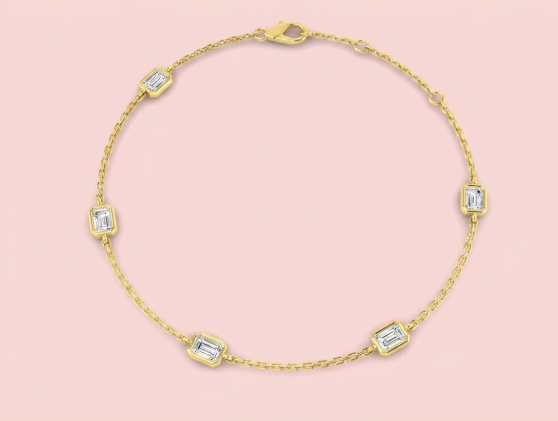 Bezel set lab grown emerald cut diamond station bracelet shown in white gold and yellow gold, featuring five emerald cut diamonds on a fine chain with lobster clasp and extender