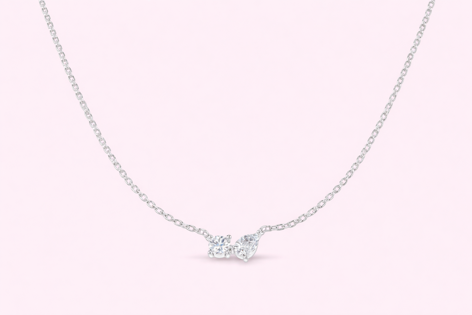 Two stone lab-grown diamond pendant with pear and round diamonds in yellow and white gold, Fogal and Barnes Harrogate UK