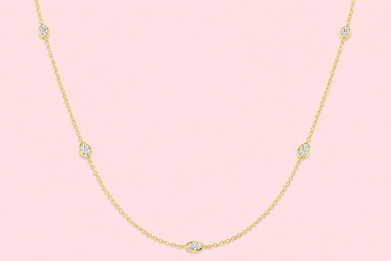 Bezel set lab grown marquise diamond station necklace on a delicate gold chain, shown in yellow gold and white gold versions on a pink background