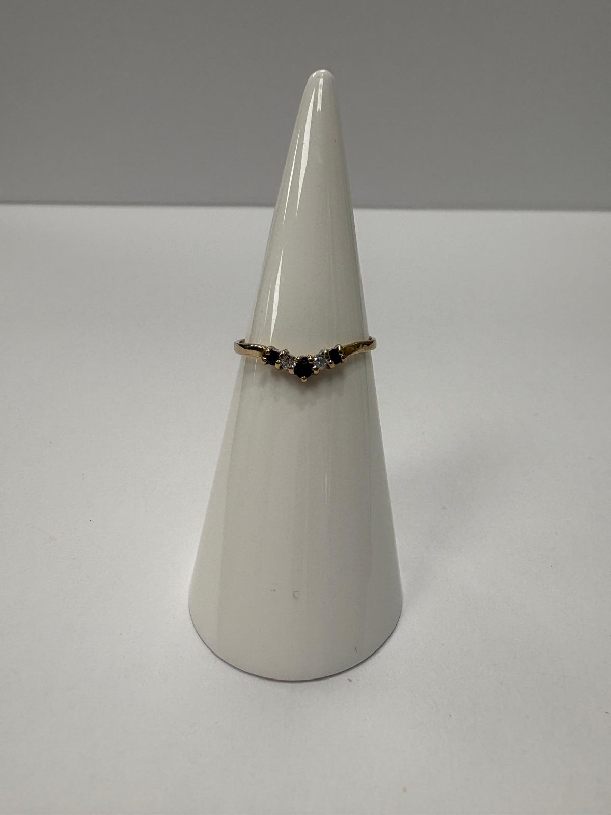 Vintage 9ct yellow gold sapphire and cubic zirconia wishbone ring size K½ with alternating blue sapphire and white CZ stones in V shape setting, shown on ring cone and close up on white background, available at Fogal & Barnes Harrogate