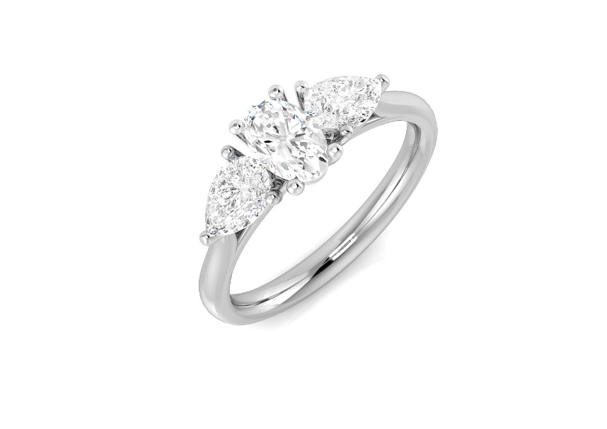 Oval and diamond pear cut three stone engagement ring set on platinum from fogal and barnes fine jewellers of harrogate