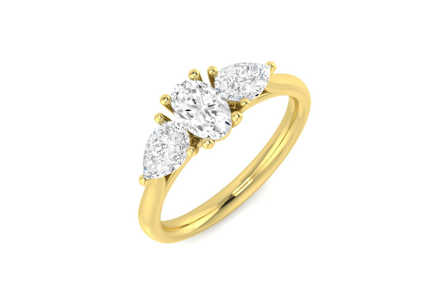 Oval and diamond pear cut three stone engagement ring set on 18k yellow gold from fogal and barnes fine jewellers of harrogate