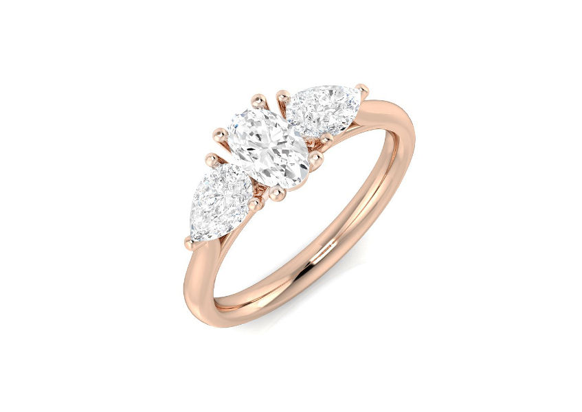 Oval and diamond pear cut three stone engagement ring set on 18k rose gold from fogal and barnes fine jewellers of harrogate