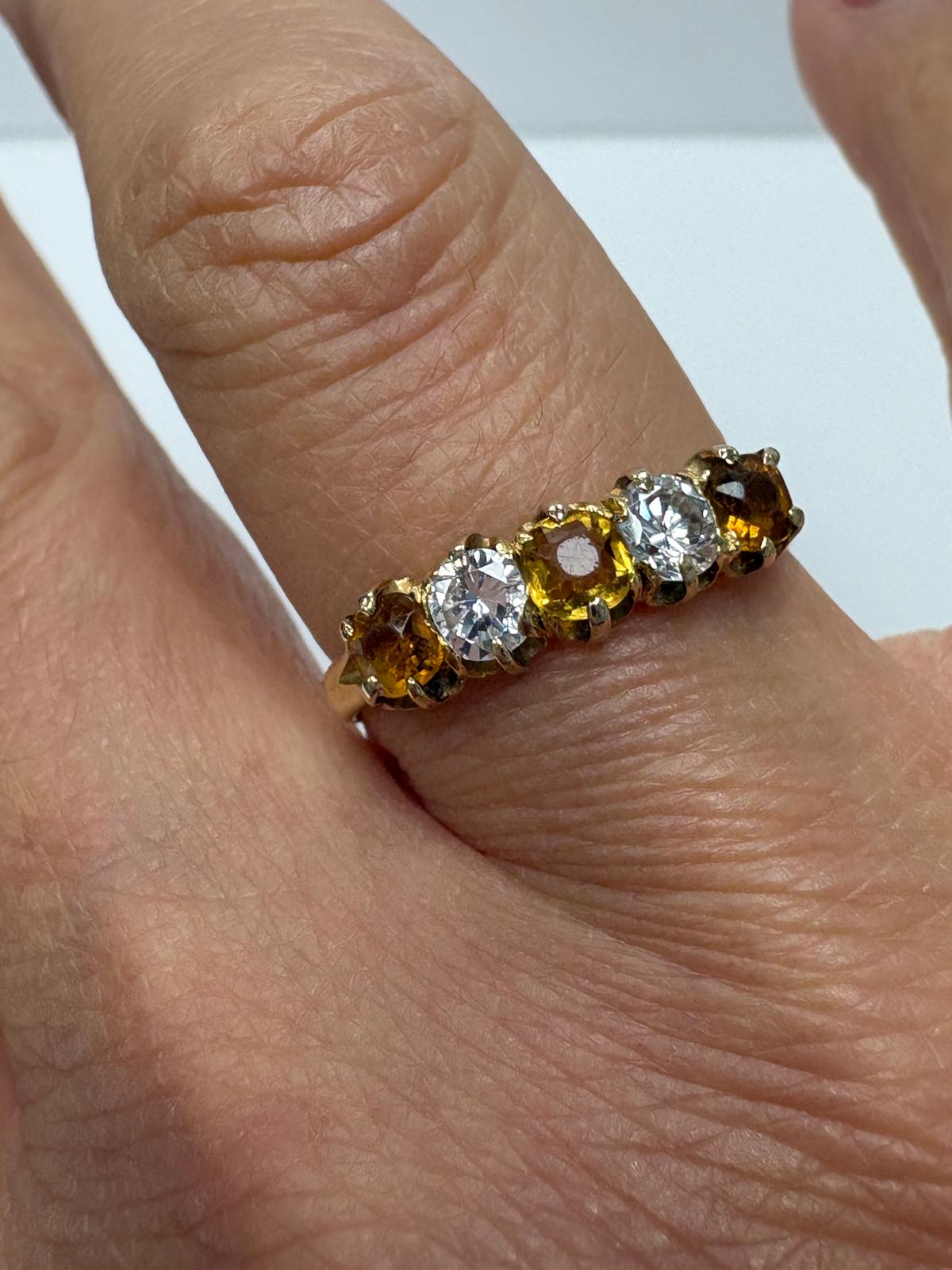 Vintage 18ct yellow gold citrine and white stone five stone graduating ring size S½ with three amber citrines alternating with two white stones in claw setting, shown on white background and worn on finger, available at Fogal & Barnes Harrogate