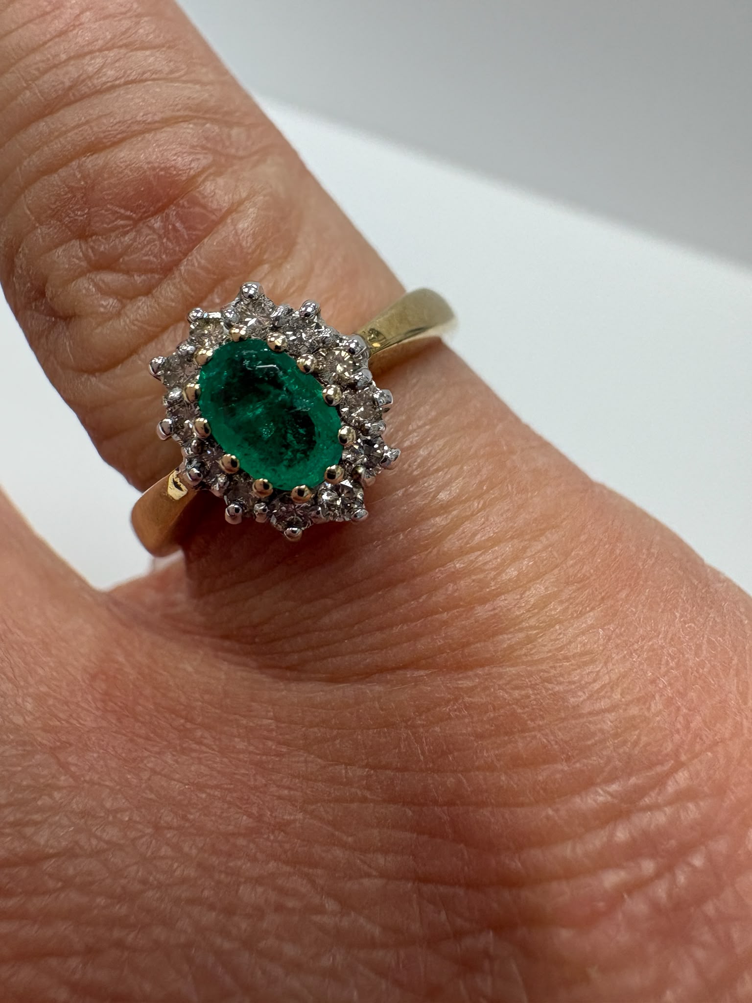 emerald and diamond ring, emerald cluster ring, second hand emerald ring UK, pre-loved emerald ring, vintage emerald ring, 9ct gold emerald ring, oval emerald ring, May birthstone ring, second hand jewellery Harrogate, second hand jewellery Leeds, second hand jewellery York, second hand jewellery Yorkshire, pre-owned emerald ring UK, antique style emerald ring, classic emerald cluster ring, buy second hand emerald ring, emerald ring size N, emerald ring near me, fine jewellery Harrogate, pre-loved jewellery