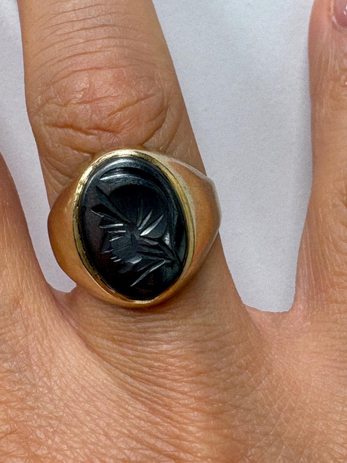 Side profile of vintage gold signet ring showing hallmark and band width
