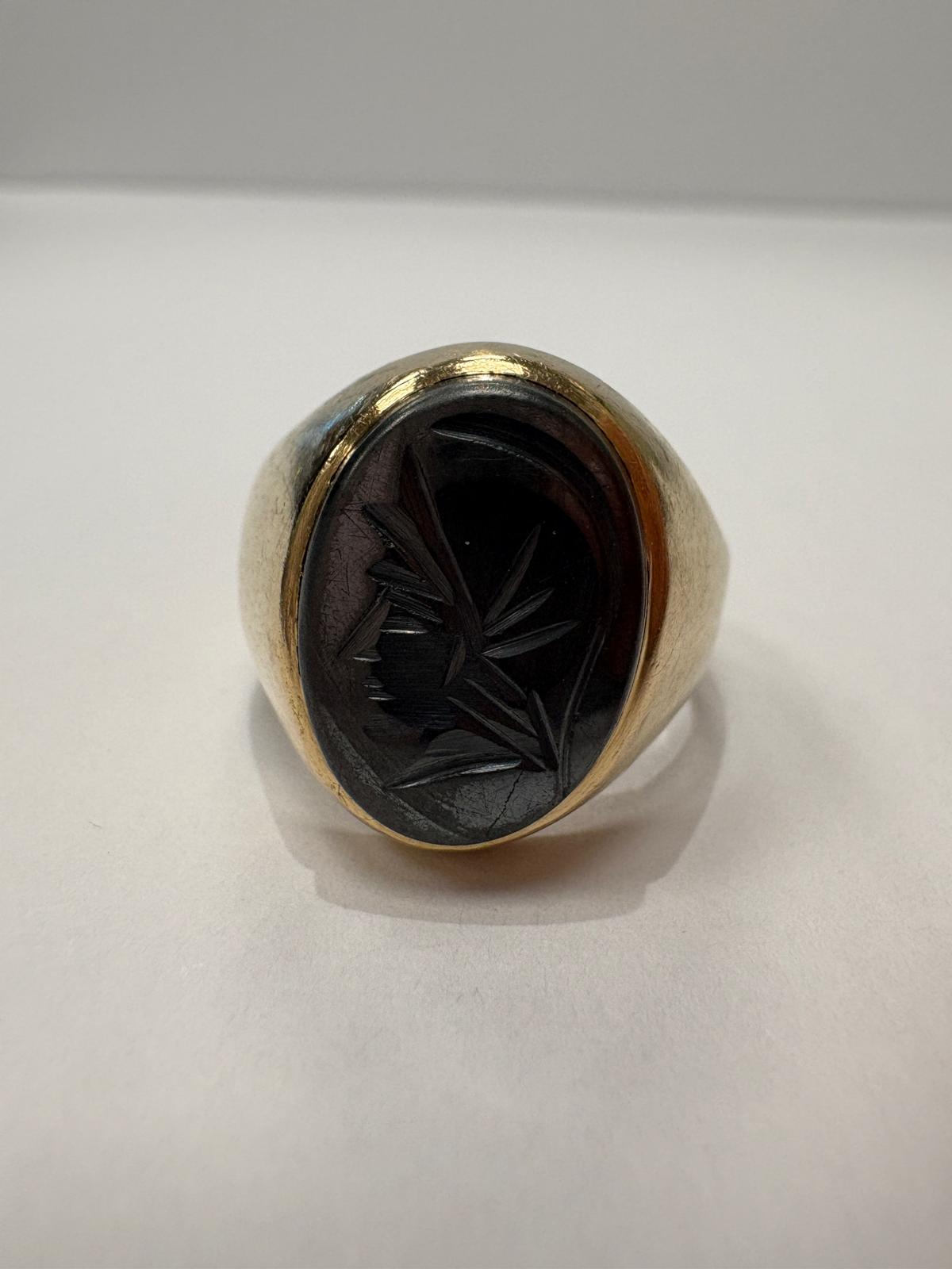 Studio photo of 9ct gold signet ring with carved hematite intaglio