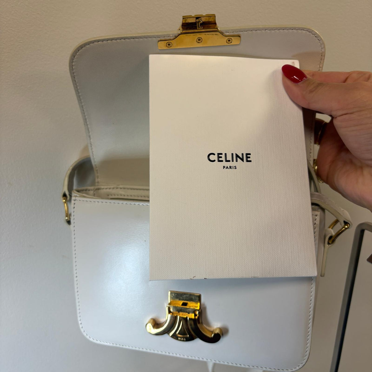 Celine Teen Triomphe, pre-loved Celine bag UK, white Celine Triomphe bag, second hand Celine handbag, Celine Triomphe shoulder bag, Celine crossbody bag, preowned designer handbag UK, Celine shiny calfskin