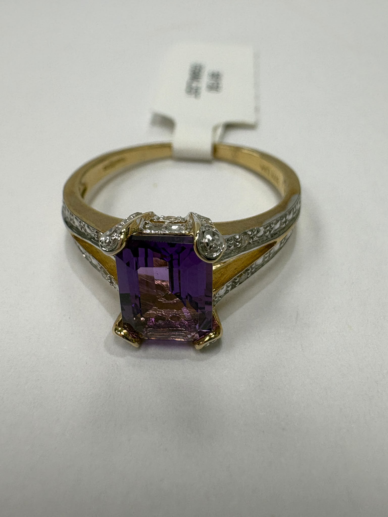 Emerald-cut amethyst and diamond ring with split-shoulder setting, 9ct gold, size N. Pre-loved, authenticated. Shop coloured gemstone jewellery in Harrogate.