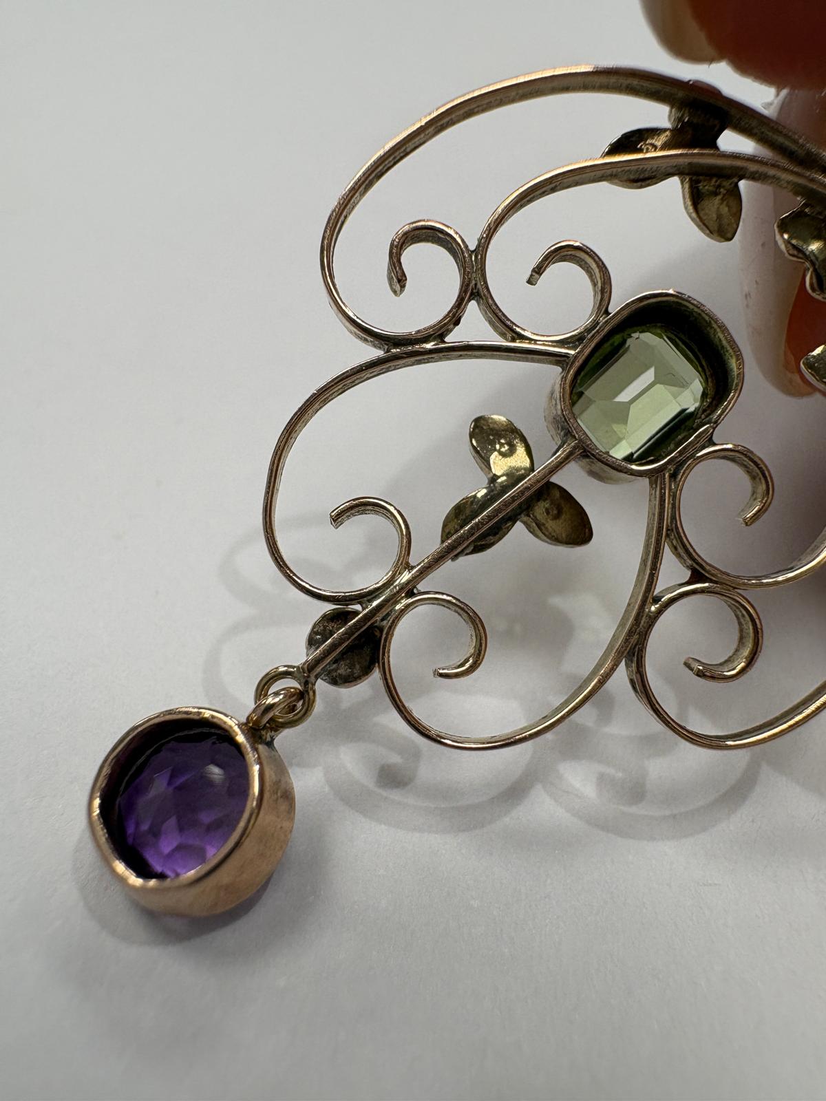 Detail of seed pearl clusters and peridot on antique Edwardian gold pendant