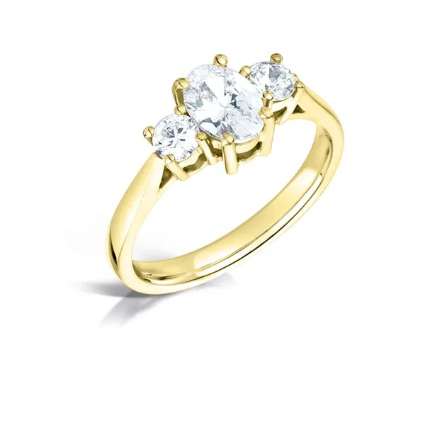 Oval and round diamond three stne engagement ring from fogal and barnes in harrogate set on 18k yellow gold