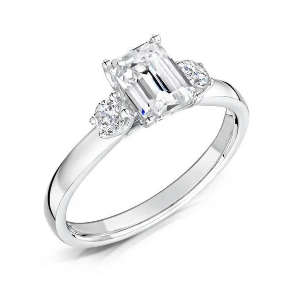 Emerald cut center diamond with 2 round diamonds set on platinum engagement three stone ring from fogal and barnes fine jewellers of harrogate