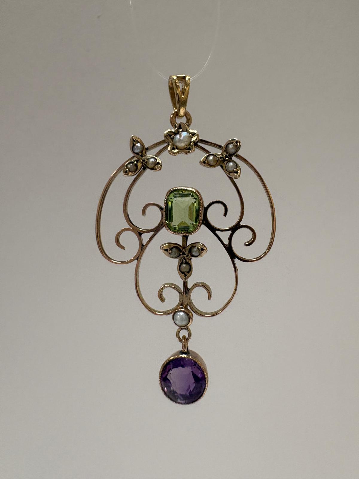 Close up of Edwardian suffragette pendant with amethyst drop and green peridot in 9ct gold
