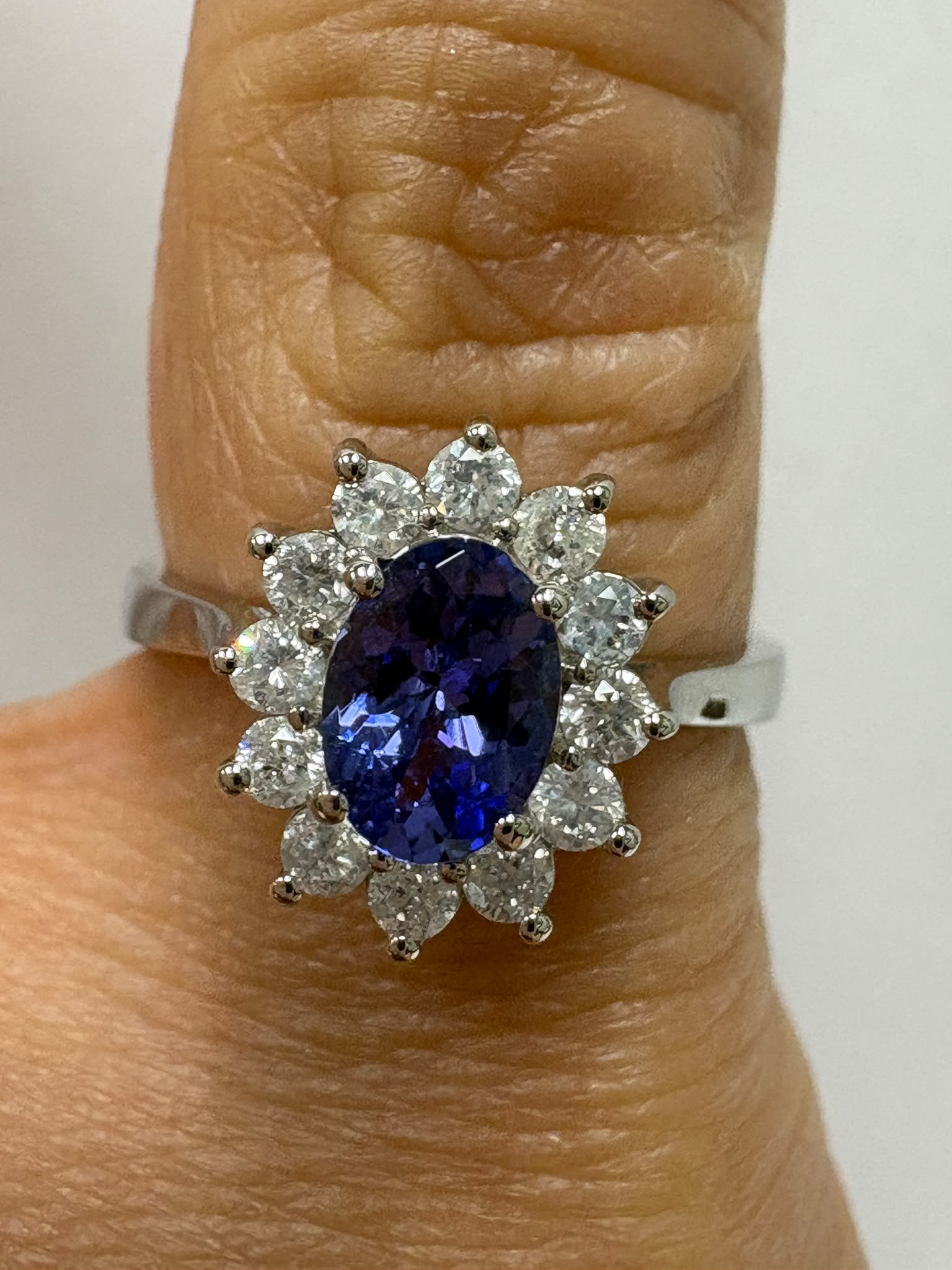 enuine pre-loved tanzanite and diamond cluster ring in 9ct white gold. 0.81ct tanzanite, 0.42ct diamonds, size M. Visit our Harrogate showroom today.